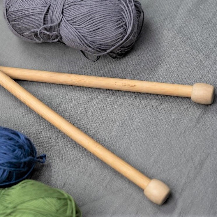 Knitting needle next to some yarn