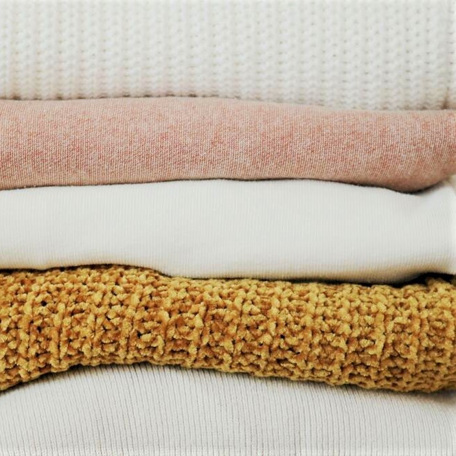 Knit sweaters pile up